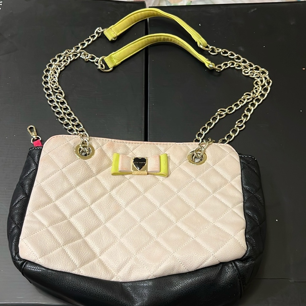 Betsy Johnson light pink & black purse with bow on front.